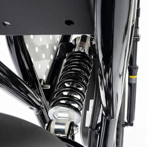 Close-up of a motorcycle suspension system with a white background